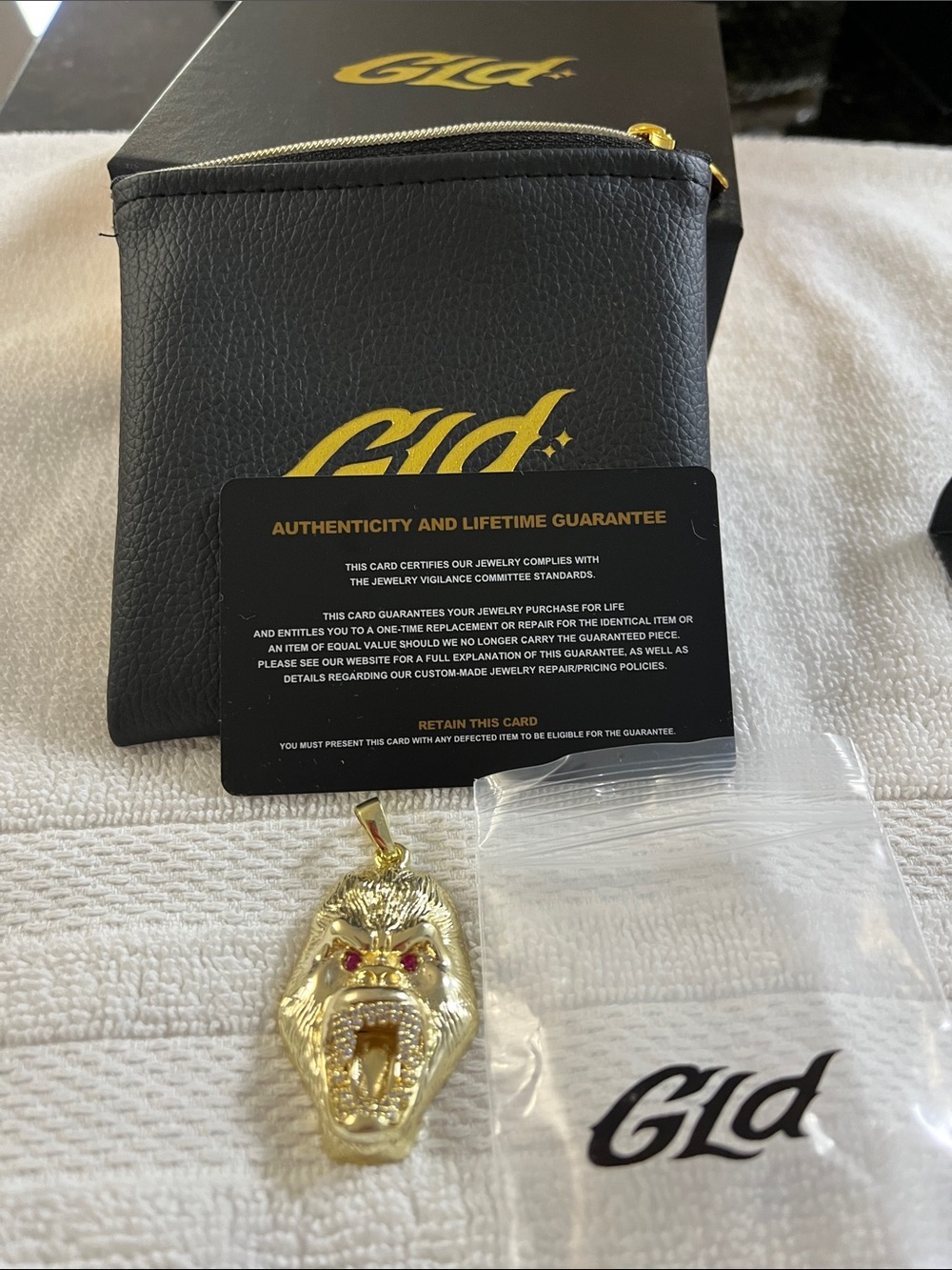 GLD Gold Lion Head Pendant with Red Eye Accents